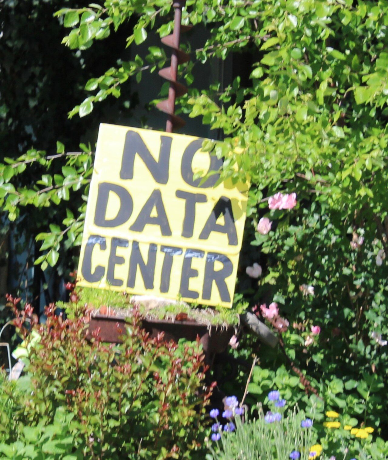 A handmade protest sign opposing an AI data center